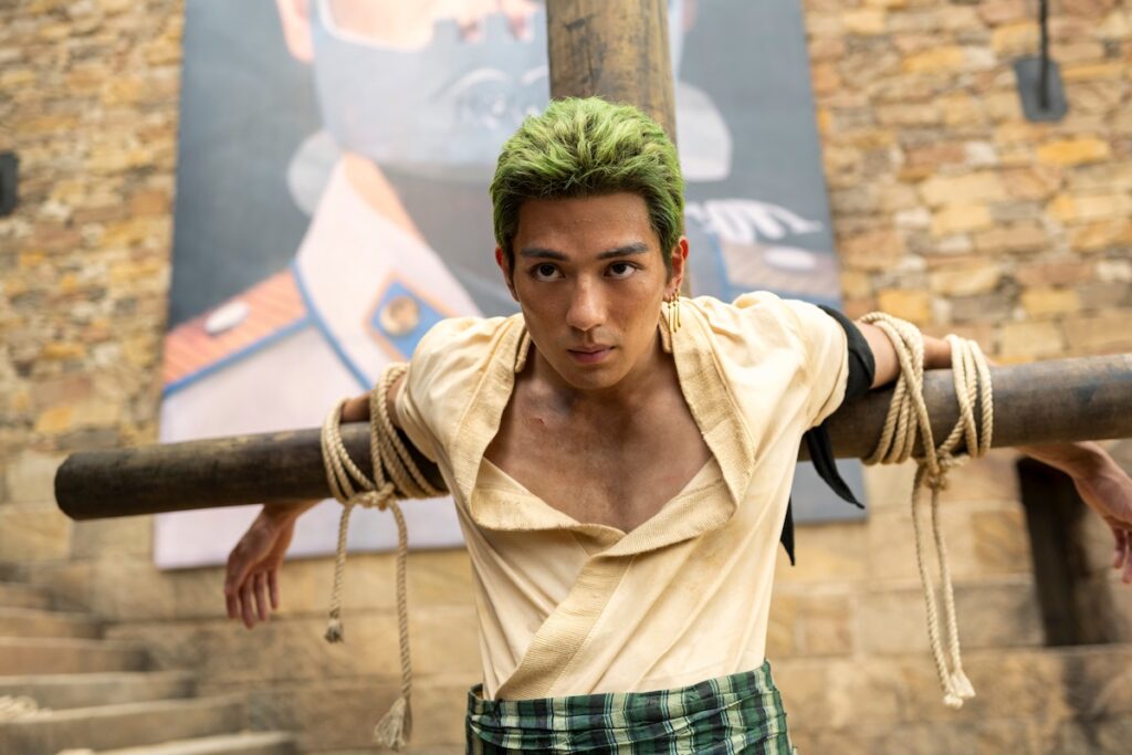 Image of Roronoa Zoro, portrayed by Mackenyu, a skilled swordsman and member of the Straw Hat pirate crew in the epic pirate adventure saga